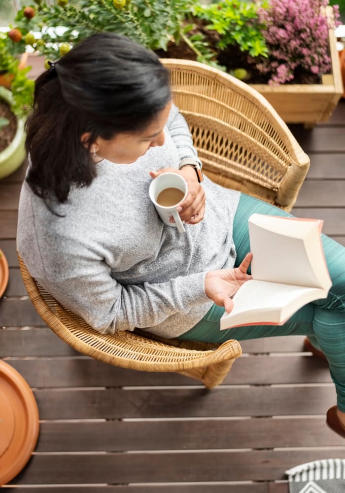 A resident sitting on their balcony at Hunt Club in Gaithersburg, Maryland