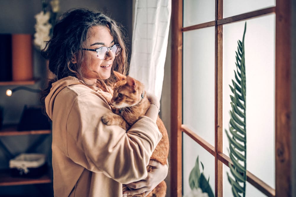 Resident holding her cat at Oaks Braemar in Edina, Minnesota
