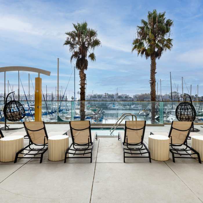 Poolside lounge chairs with marina view at St Tropez Apartments in Marina Del Rey, California 