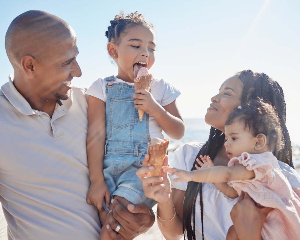 Young family having ice cream on the beach near The Maggie Flats and The Maggie Towns in Jacksonville, Florida