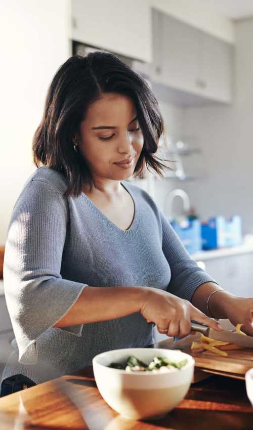 Resident preparing food in her modern kitchen at Sage by Vintage in Reno, Nevada