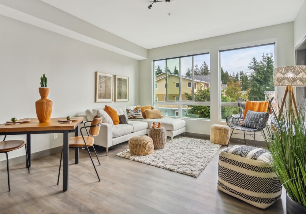 A beautiful living room setting with oversized windows at Alta Crossing in Marysville, Washington