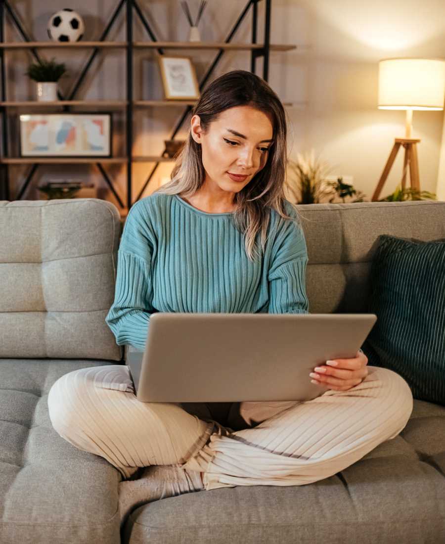 A woman focusing on her work laptop at Waters Edge in Sacramento, California