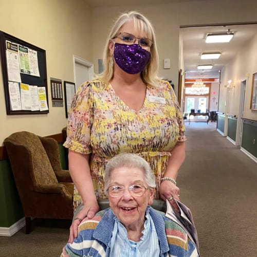 Masked caretaker with a resident at Canoe Brook Assisted Living in Duncan, Oklahoma