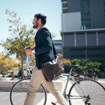 Resident holding a coffee cup with a bicycle near Monaco South in Denver, Colorado