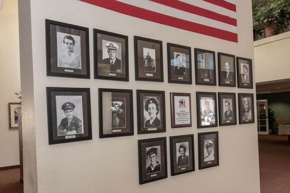 Wall of Veterans photos at Hilltop Commons Senior Living in Grass Valley, California