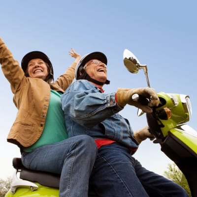 Couple scootering at The Citadel Senior Living in Mesa, Arizona