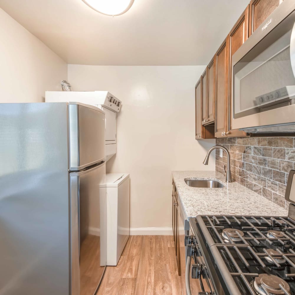 Kitchen with in-unit laundry at Quail Hollow Apartment Homes in Glen Burnie, Maryland