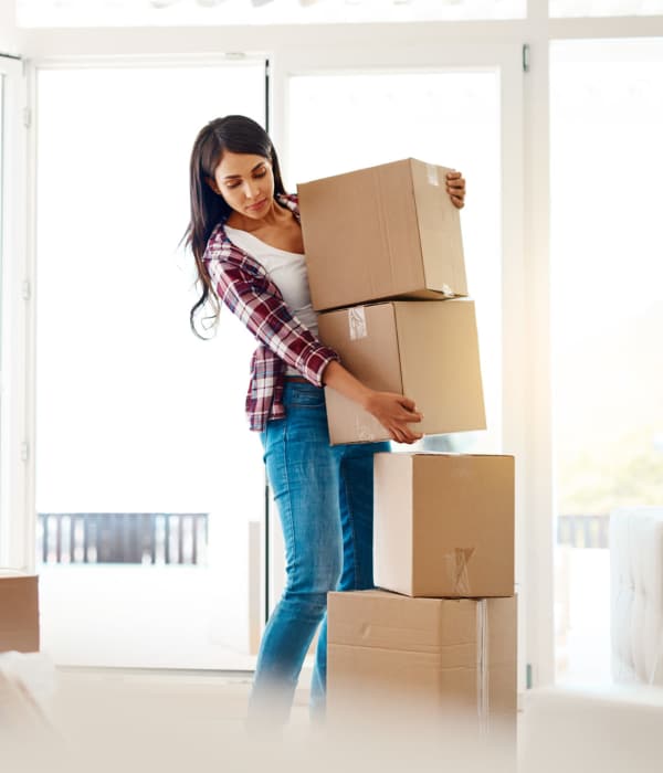 A customer holding a packed boxs near Storage Hub - Military in San Antonio, Texas