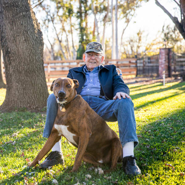 A resident and his dog at The Crest at Citrus Heights in Citrus Heights, California.