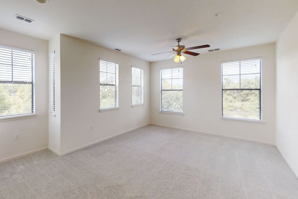 Ceiling fan and plush carpeting in the living area of a model home at The Hawthorne in Jacksonville, Florida