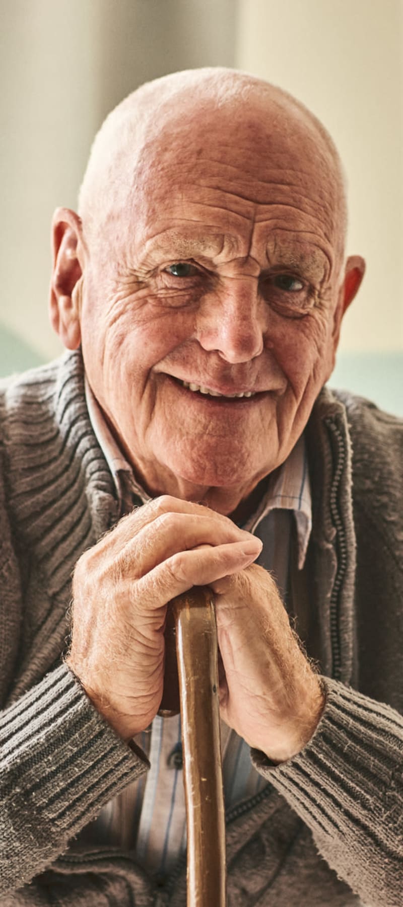 Happy resident looking into the camera at Transitions At Home - Central in Stevens Point, Wisconsin