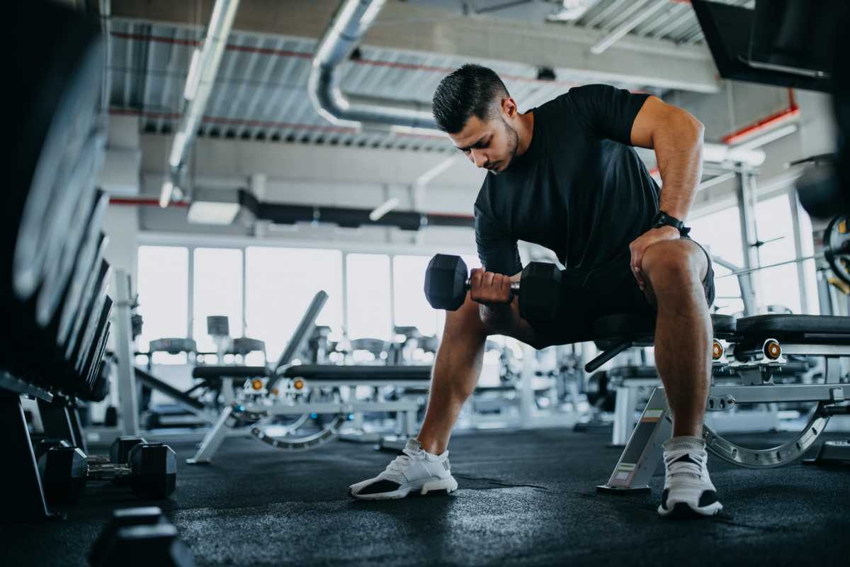 Resident working out in fitness center at Traditions at Colorado Springs in Colorado Springs, Colorado