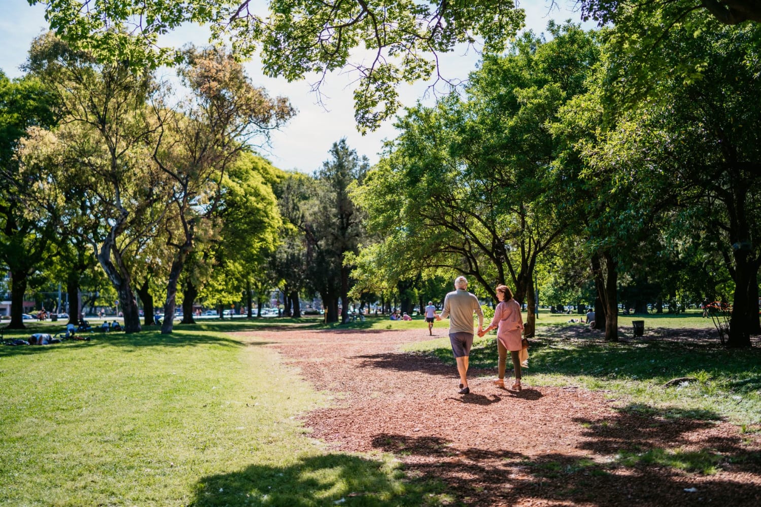 Residents enjoy a walk in the park at Meridian Oaks Apartments in Greenwood, Indiana