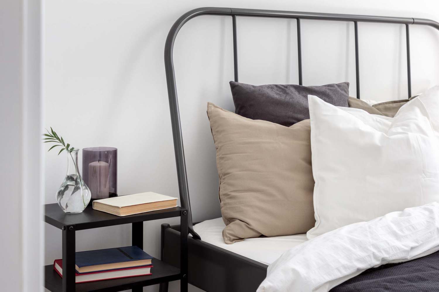 Cozy bed in an apartment at South Creek Apartments in Littleton, Colorado