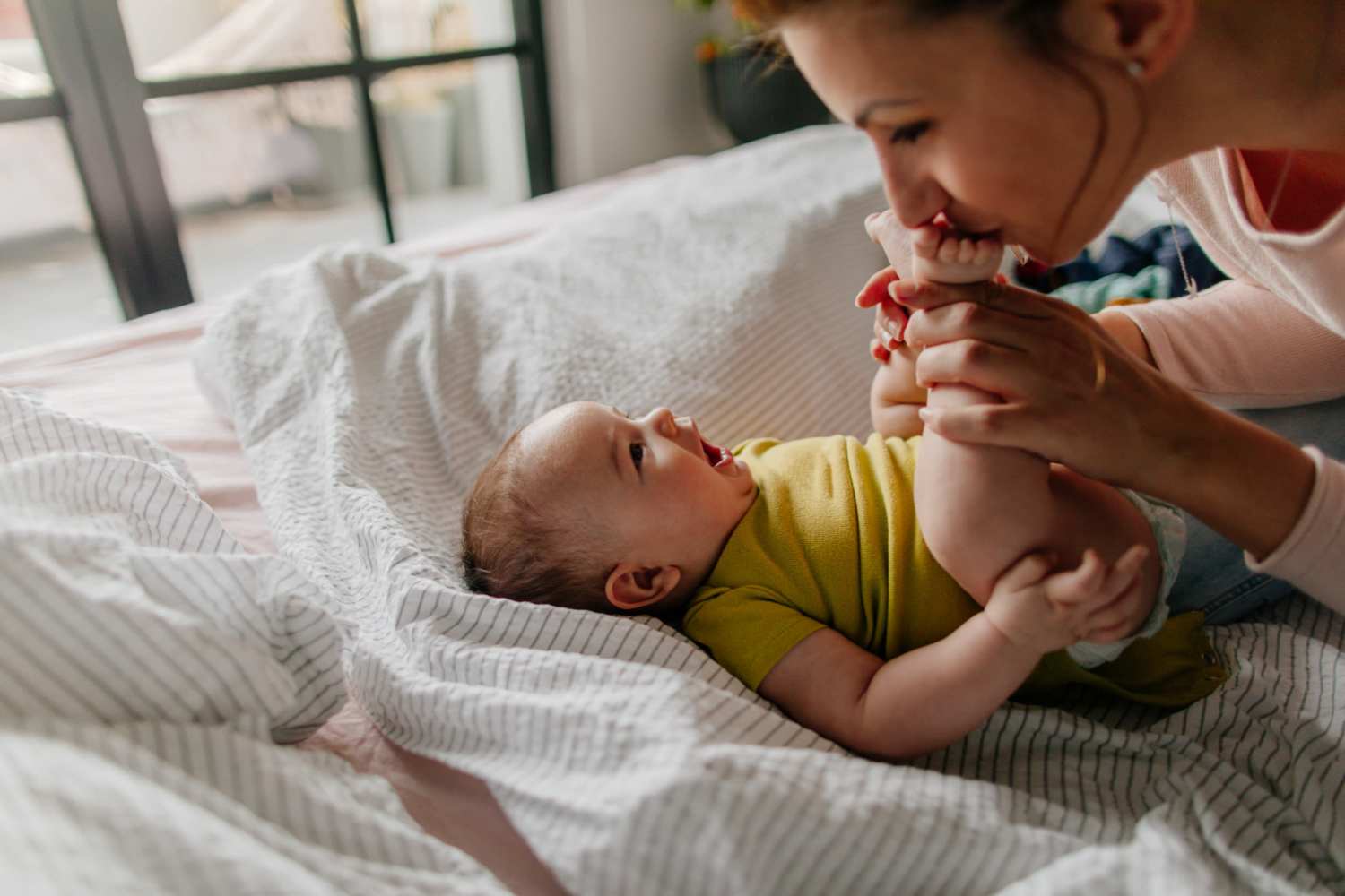 Resident playing with her kid in her apartment at Saratoga Place Apartments in Suffolk, Virginia