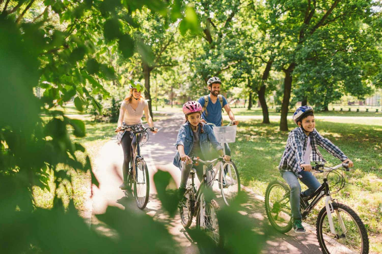 Resident family cycling at green trail near Tribecca Pointe Apartments in Hurst, Texas