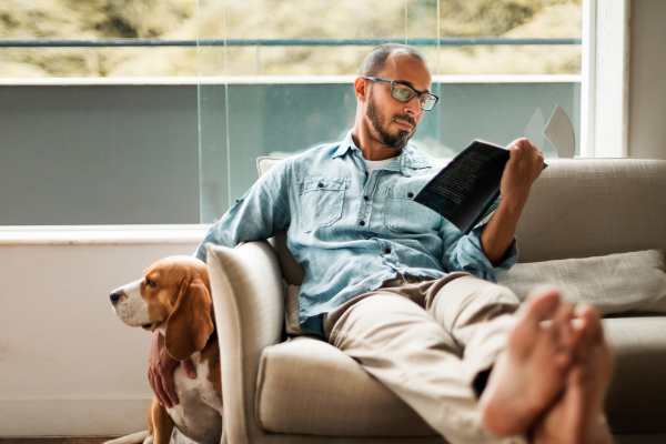 Dog and owner in living room at The Legends At ChampionsGate in ChampionsGate, Florida