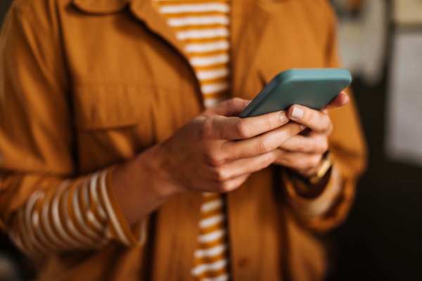 Women using her phone at Raystone Apartments in Phoenix, Arizona