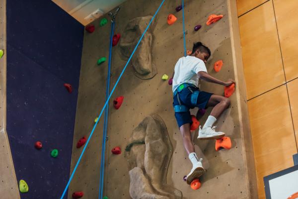 Resident doing rock climbing near The Summit At Metrowest in Orlando, Florida
