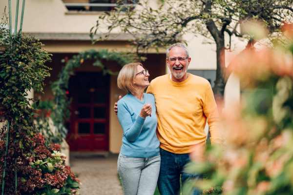Couple walking together in community area at Woodbrook Apartments in Three Rivers, Michigan