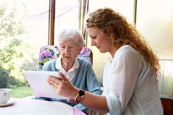 Senior women getting assistance at The Pineapple House at Sapphire Lakes in Naples, Florida