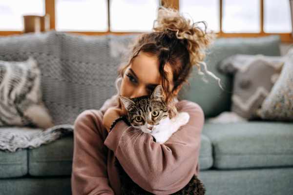 Resident woman with her cat in a modern living room at Falls Creek in Sanford, North Carolina