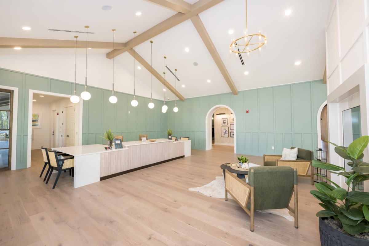 Indoor community area with high ceilings, cabinets and chairs