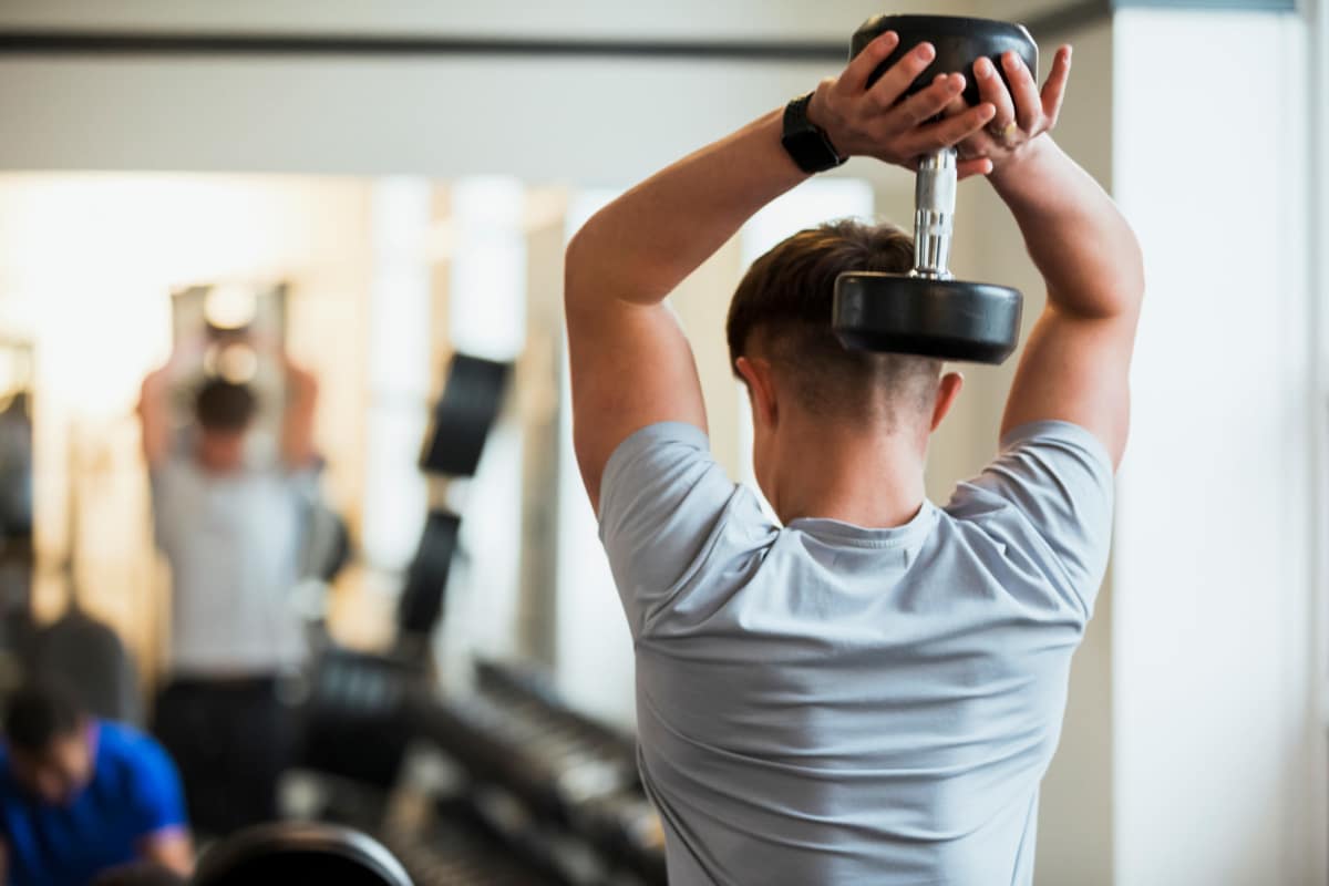 Men doing exercise with dumbbell at Fieldstone in Olathe, Kansas