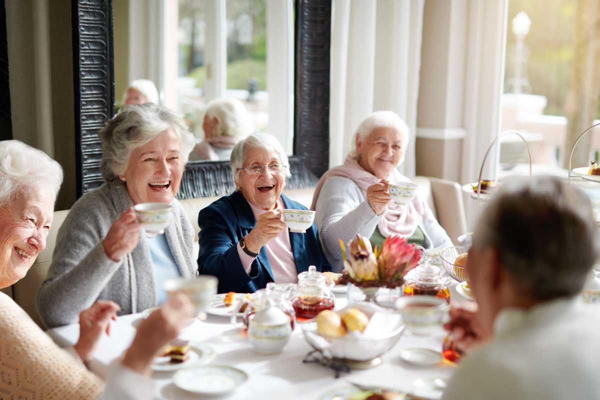 Active senior residents socializing in a restaurant near Watermere on Oak Street in Roanoke, Texas