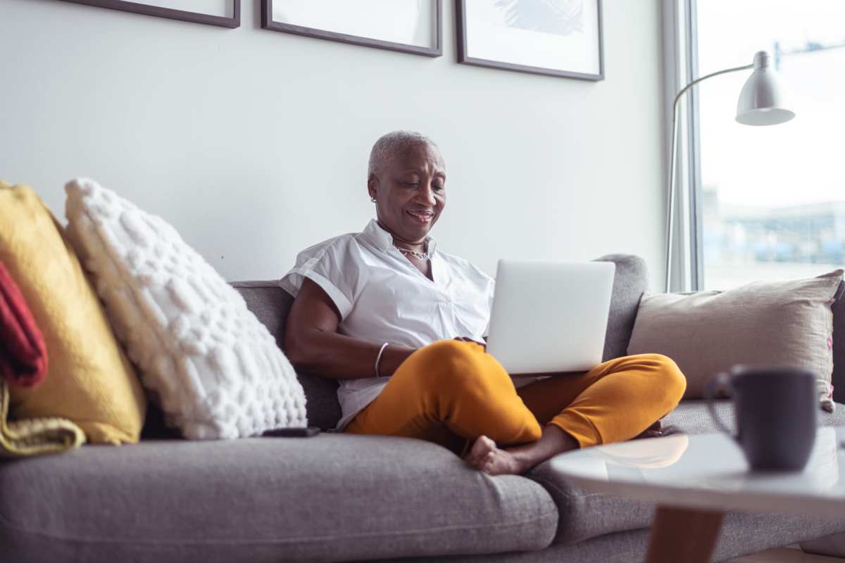 Resident relaxing on the couch at home in Watermere on Oak Street in Roanoke, Texas