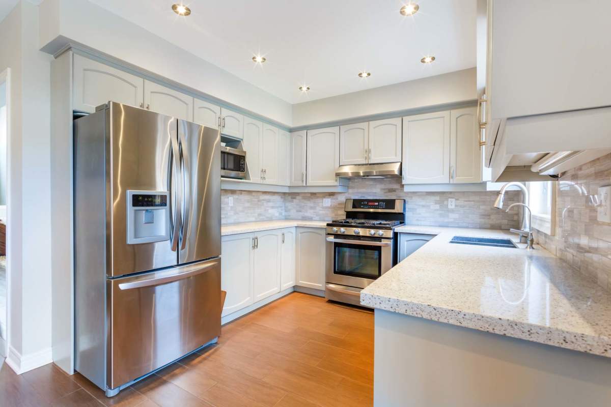 Fully equipped kitchen with stainless-steel appliance at Republic House at Frisco Bridges in Frisco, Texas