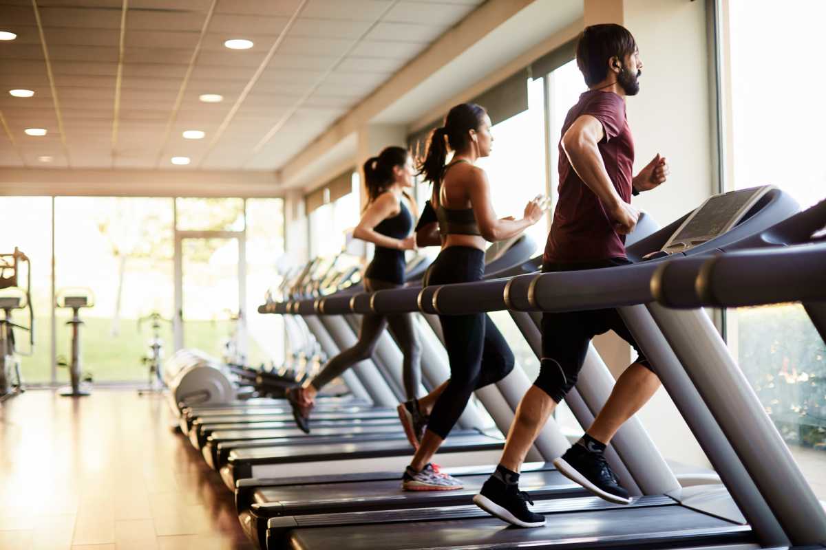 Residents jogging on the treadmill in fitness studio at Republic House at Frisco Bridges in Frisco, Texas