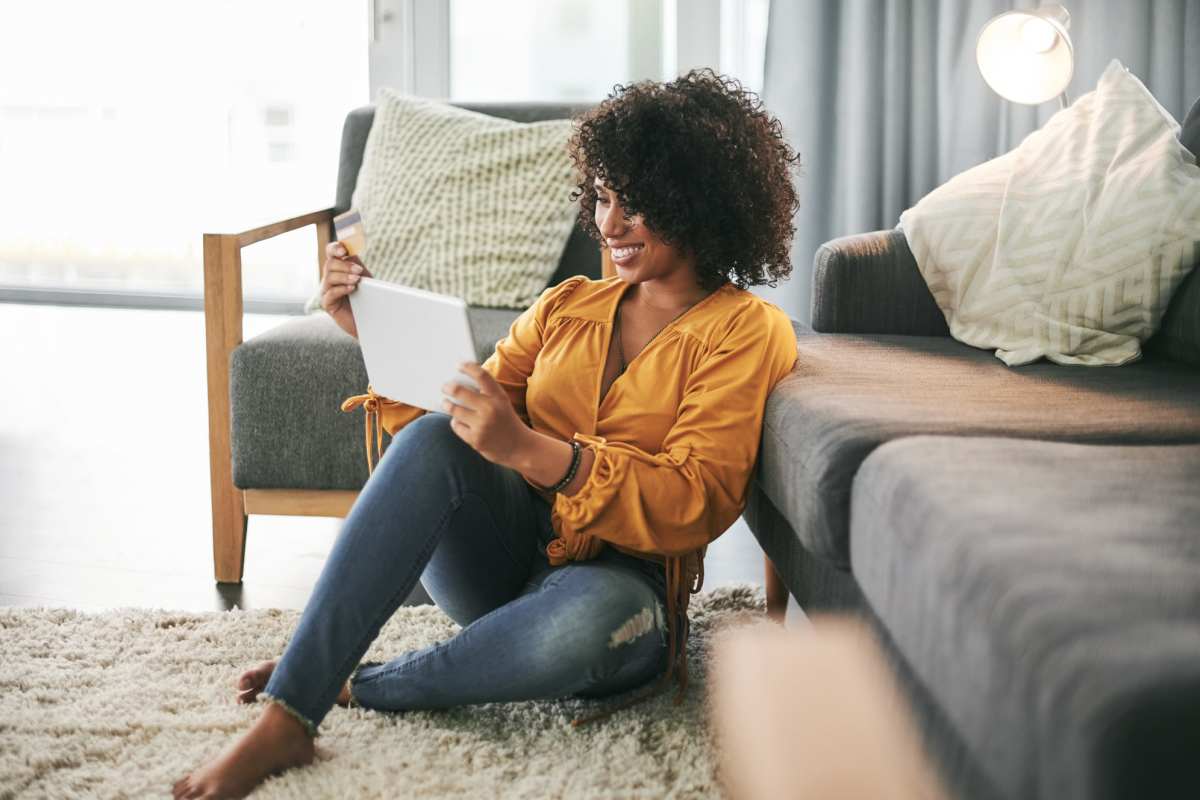 Women playing on her tablet in the living room at Greenacres Village in Bossier City, Louisiana