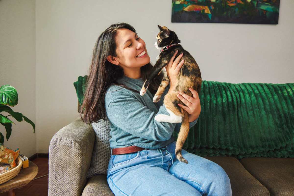 Resident with her cat at Century Travesia, Austin, Texas