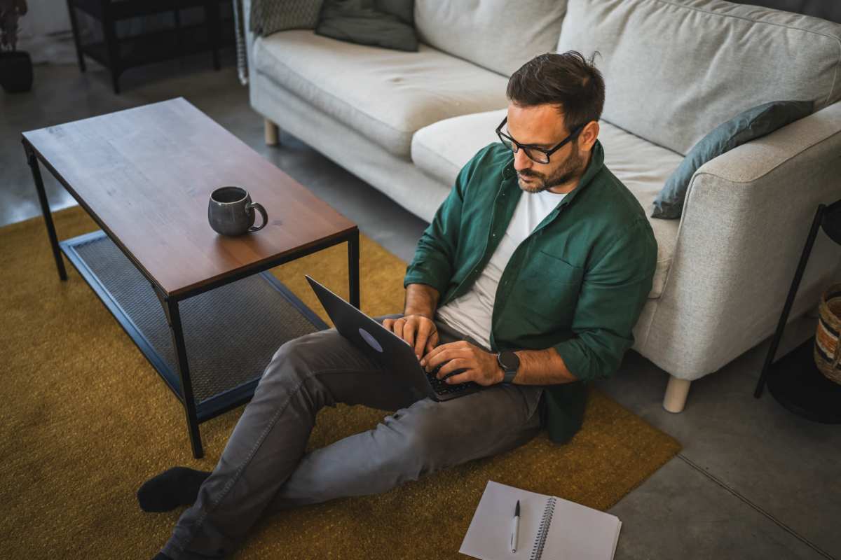 Resident working in her laptop in the living area at South City Apartments in Summerville, South Carolina