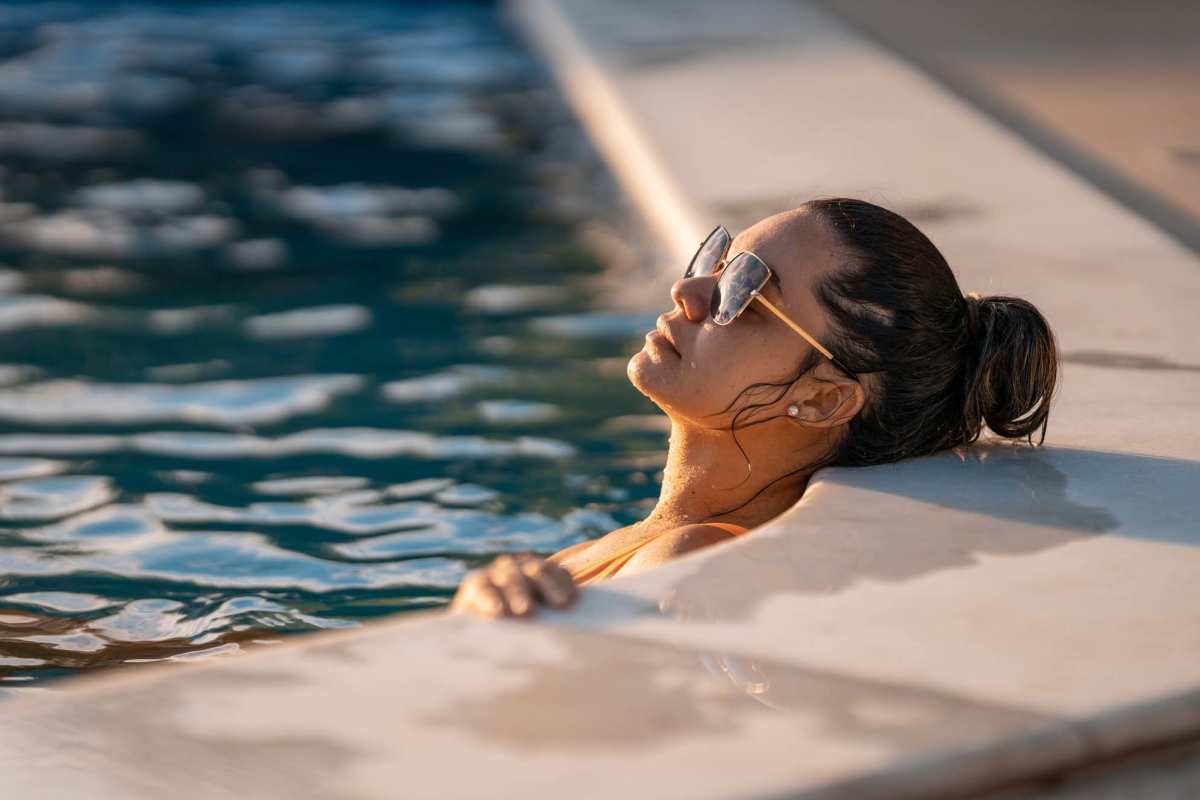 Resident relaxes in the pool at Atlas at Cabot in Cabot, Arkansas