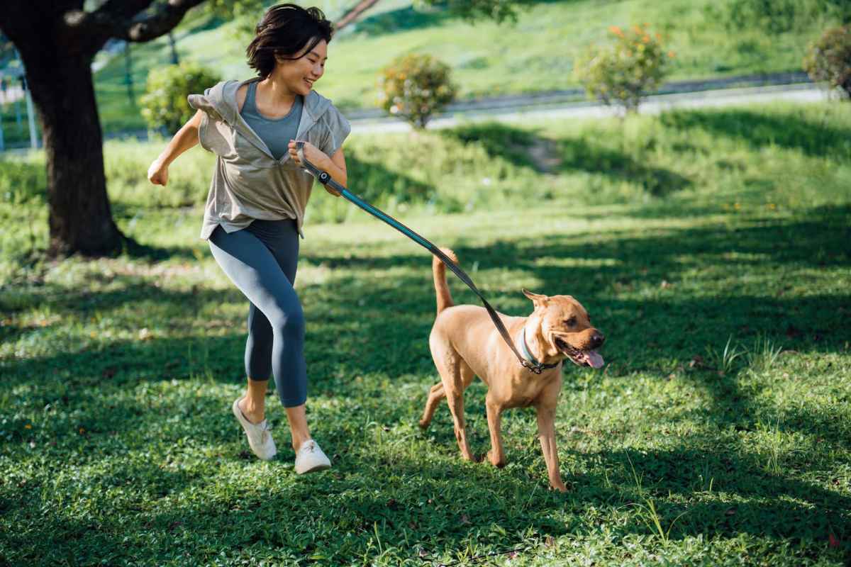 Resident woman with pet dog in dog park at Falls Creek in Sanford, North Carolina