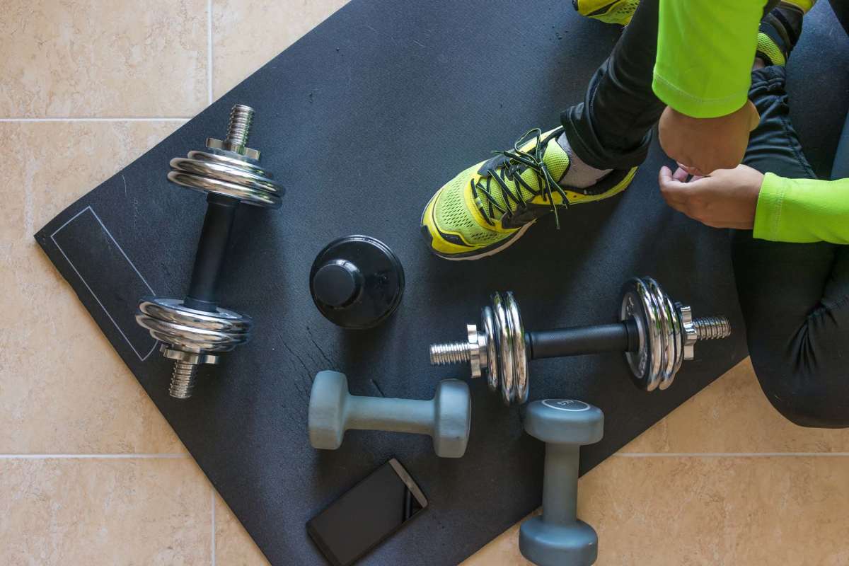 Resident in a fitness center with equipment at The Heights at Waterpointe in Flowood, Mississippi