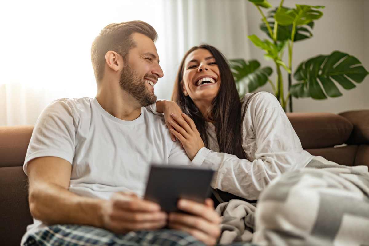 Happy couple relaxing in their living room at Lakeside in Mt Pleasant, Texas