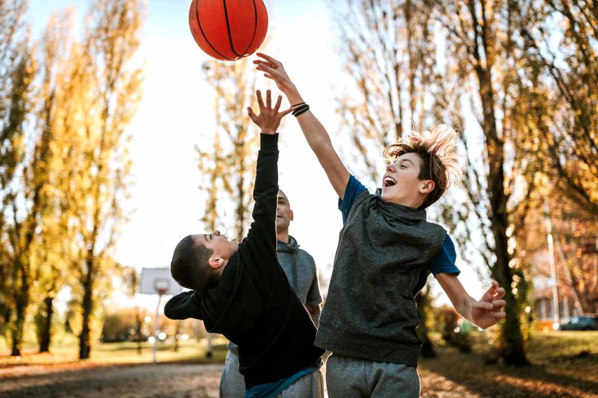 Kids playing in the basket ball at Meadowbrook Plaza in Houston, Texas