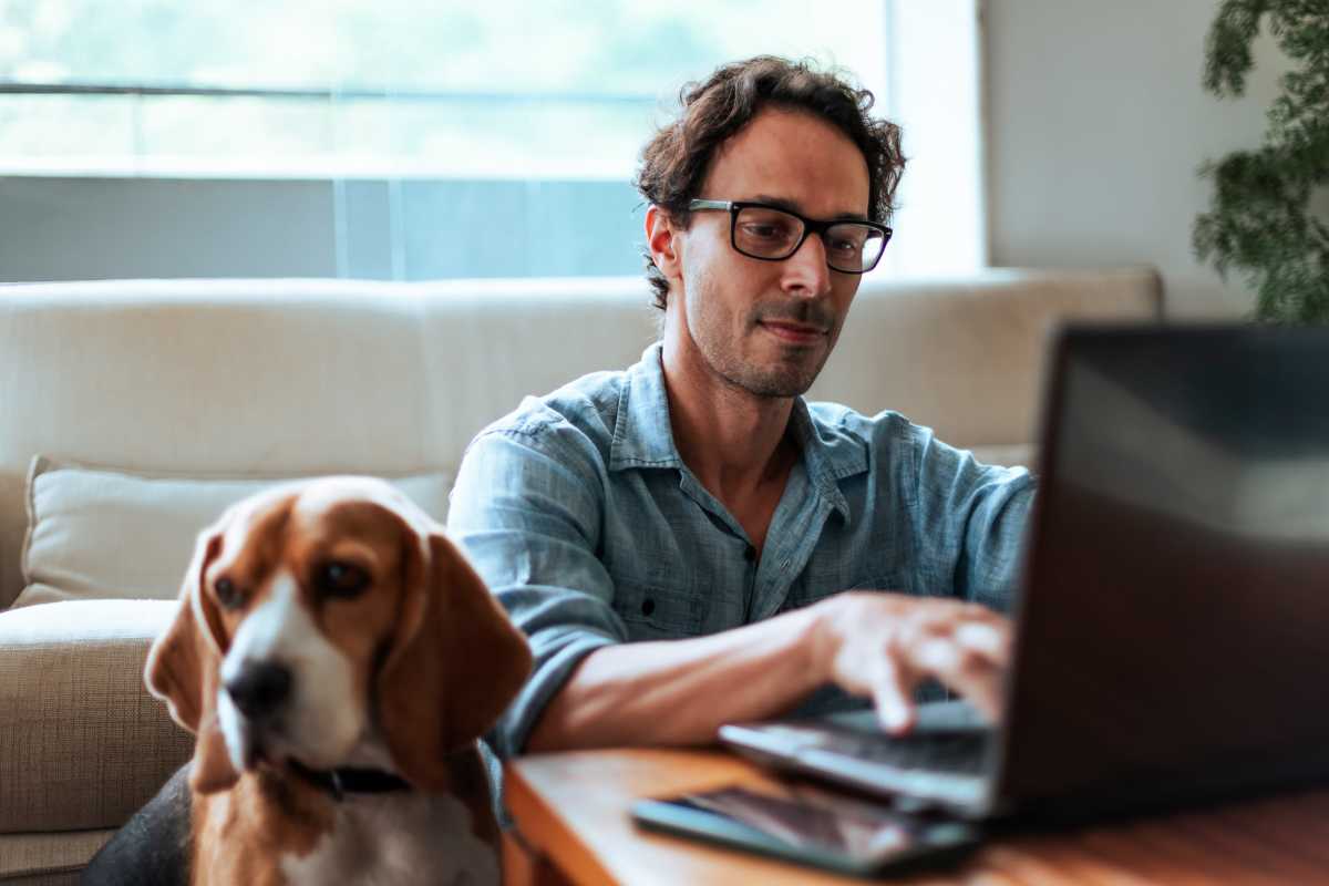 Resident with his laptop at The Terraces At Copper Leaf in Nixa, Missouri