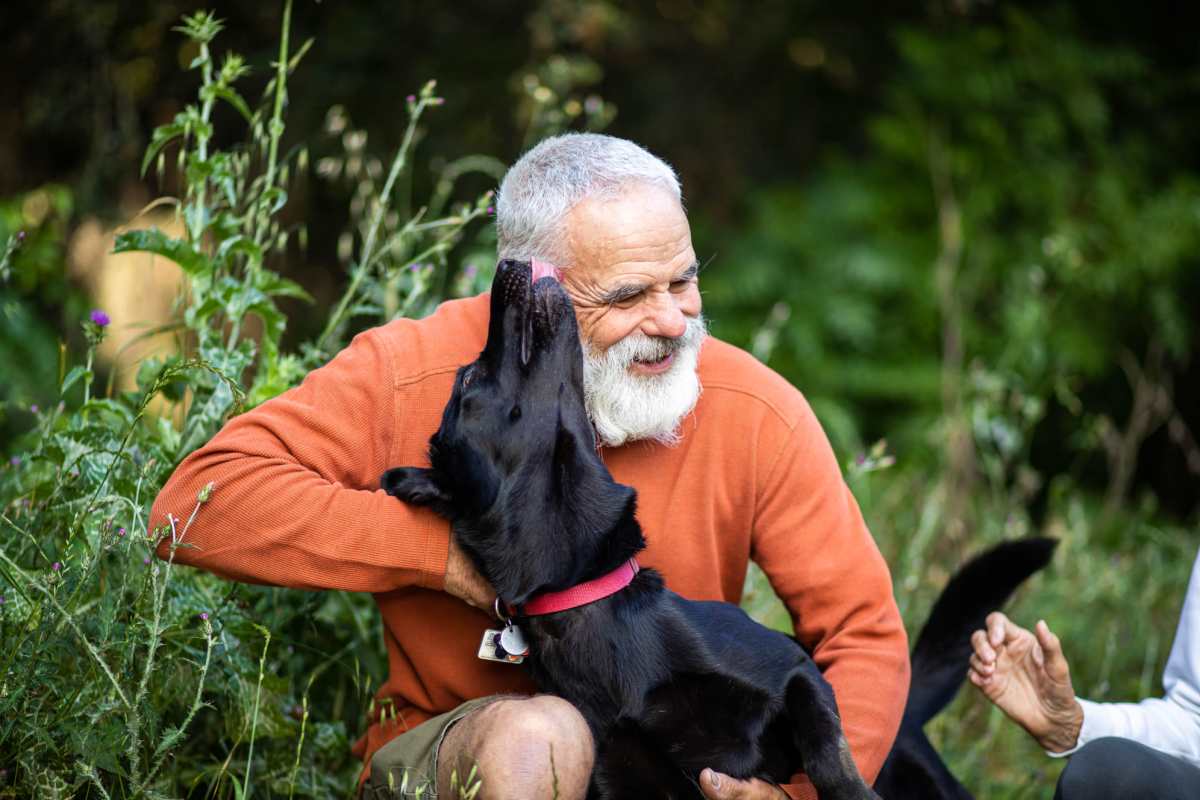 Resident playing with his dog at Villas At Mesa Ridge in Fountain, Colorado