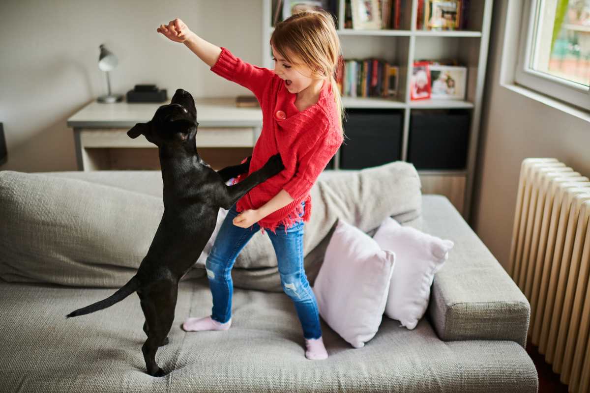 Kid playing with her dog at Rosemont At Lakewest in Dallas, Texas 