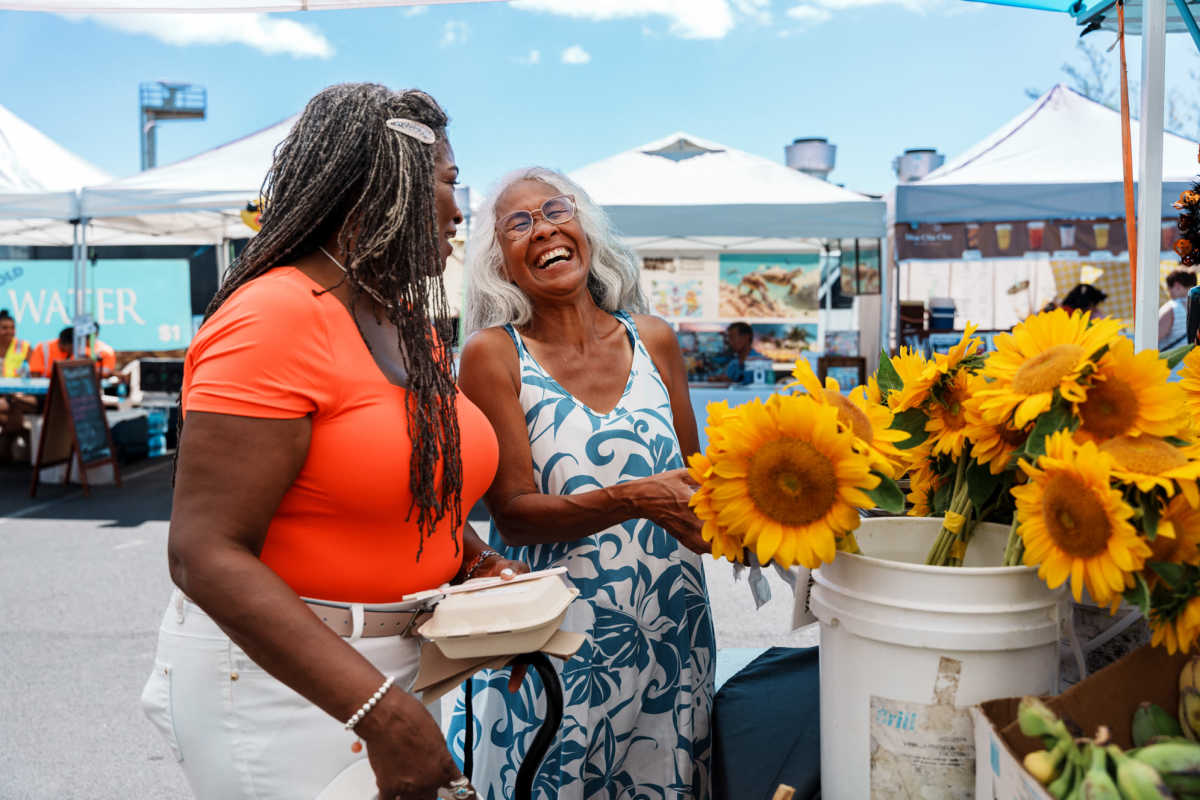 Women enjoying flowers at a market near Rollingcrest Commons in Hyattsville, Maryland 