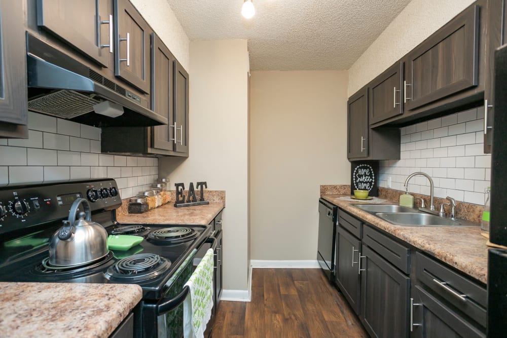 Kitchen with dark cabinets at The Village at Crestview Apartments in Madison, Tennessee