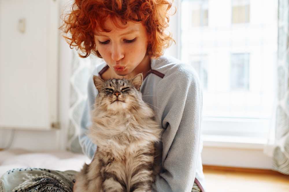 A resident petting a cat at Woodforest Chase in Houston, Texas