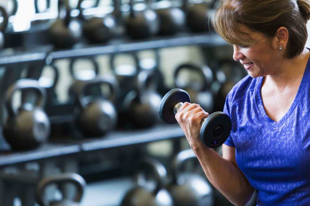 Resident working out in a fitness center at Park Terrace Apartment Homes in Muskegon,Michigan