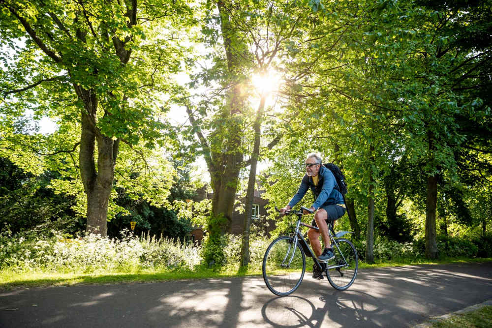 Resident cycling in a park near Peppermill Farms in Indianapolis, Indiana