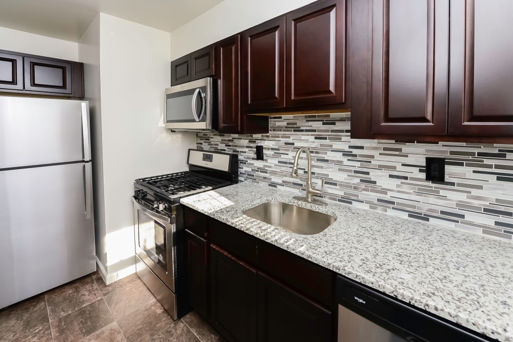 Renovated kitchen with tile backsplash at Elmwood Village Apartments & Townhomes in Elmwood Park, New Jersey